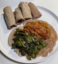 misir and gomen on a bed of injera